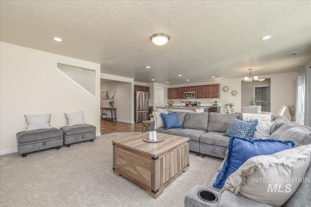 19118 Ralston Way, Caldwell, ID 83605 - living area with recessed lighting, a chandelier, a textured ceiling, and light colored carpet