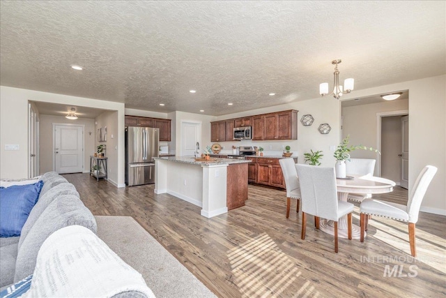 19118 Ralston Way, Caldwell, ID 83605 - dining space featuring light wood-style flooring, a chandelier, a textured ceiling, and recessed lighting