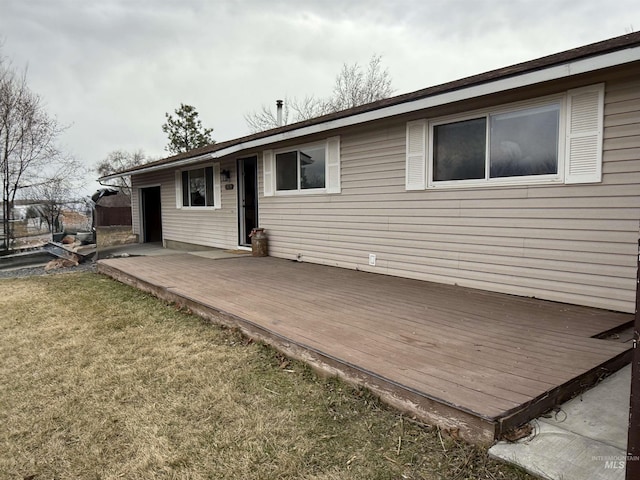 rear view of property featuring a yard and a deck