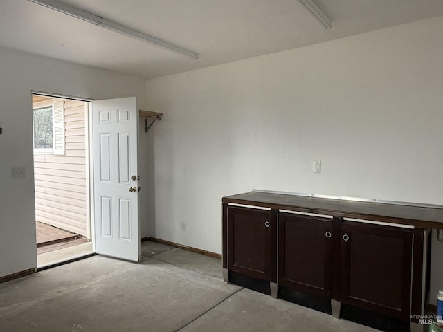 interior space featuring baseboards and concrete floors