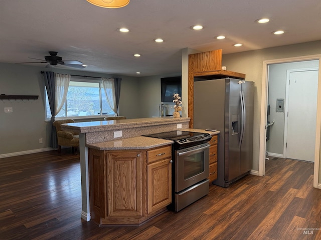 kitchen featuring brown cabinetry, dark wood-style floors, recessed lighting, and stainless steel appliances