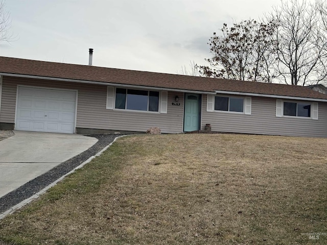 ranch-style home with an attached garage, concrete driveway, and a front lawn