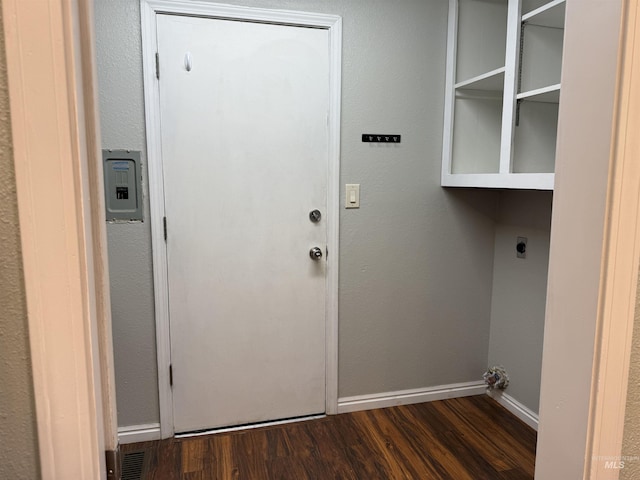 laundry room featuring electric dryer hookup, baseboards, wood finished floors, and laundry area