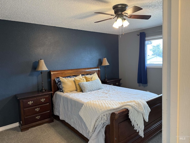 carpeted bedroom with baseboards, a textured ceiling, ceiling fan, and a textured wall