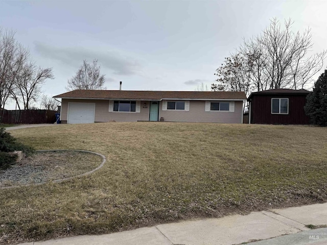 single story home with a garage and a front lawn