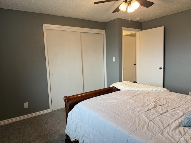 bedroom with baseboards, a closet, carpet floors, and a textured ceiling