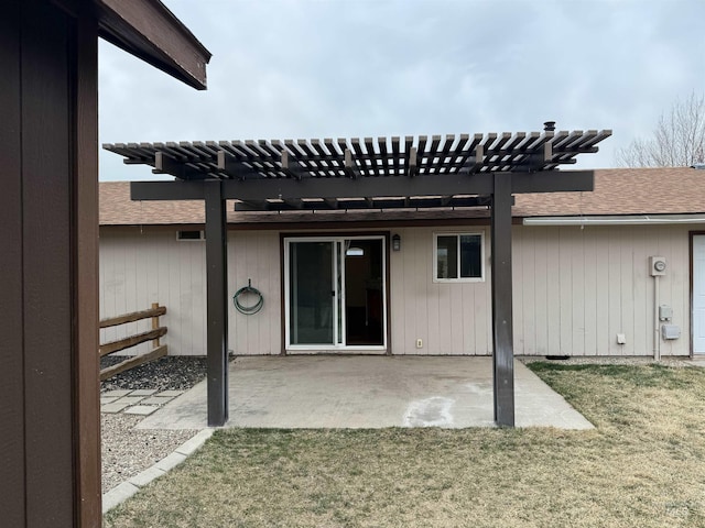 rear view of property featuring a shingled roof, a patio area, a pergola, and a lawn