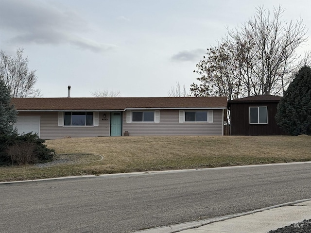 single story home with a front yard and a garage