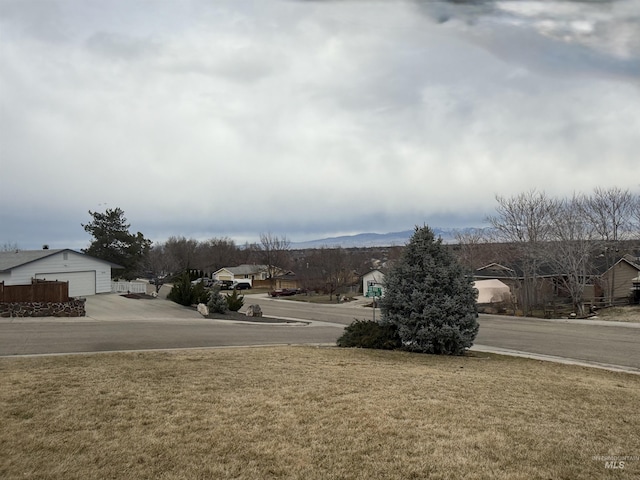 view of yard featuring a garage and a residential view