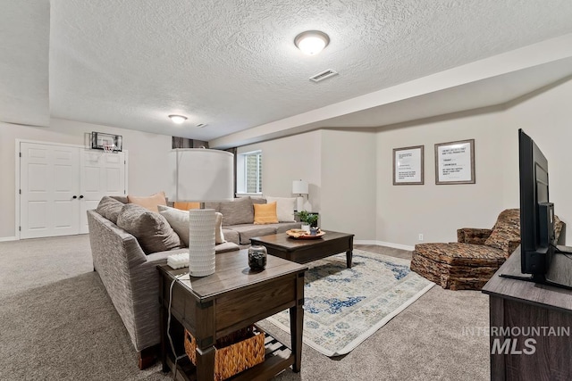 carpeted living room with a textured ceiling