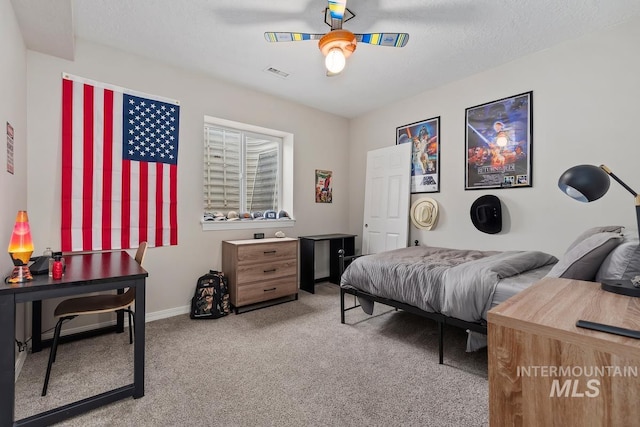 bedroom with carpet, ceiling fan, and a textured ceiling