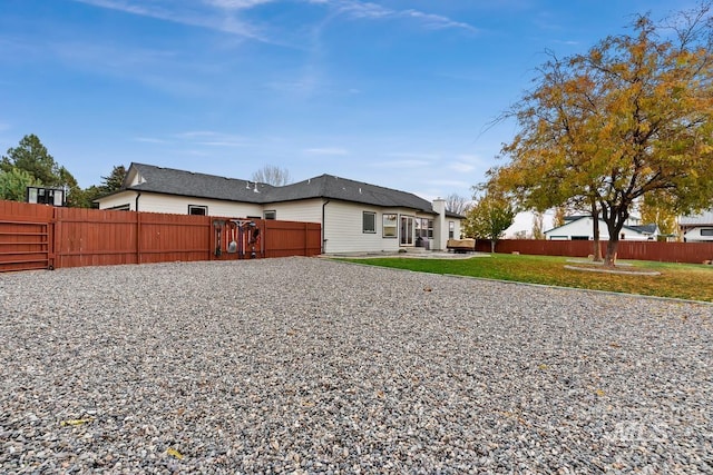 rear view of property with a lawn