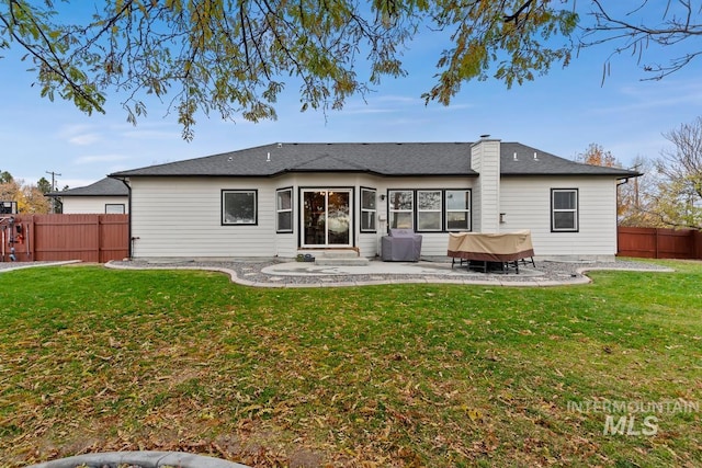 back of property featuring a yard and a patio area