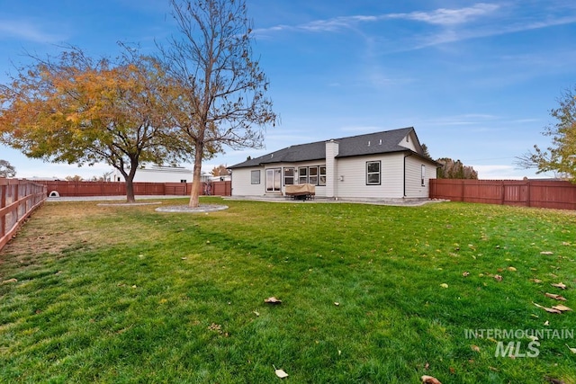 rear view of house with a patio area and a yard