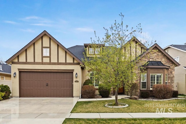 view of front of home featuring concrete driveway, stucco siding, and an attached garage