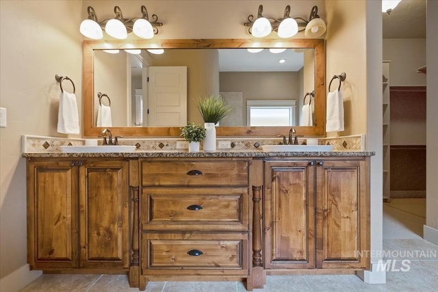 bathroom featuring double vanity and a sink