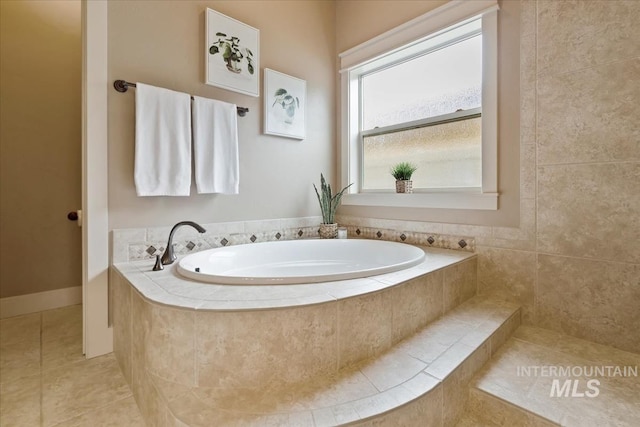 bathroom featuring tile patterned floors and a garden tub