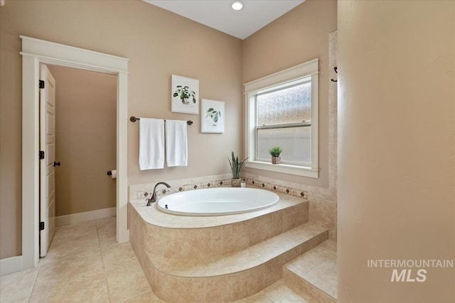 bathroom featuring a garden tub and tile patterned flooring