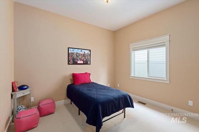 bedroom with visible vents, baseboards, and carpet