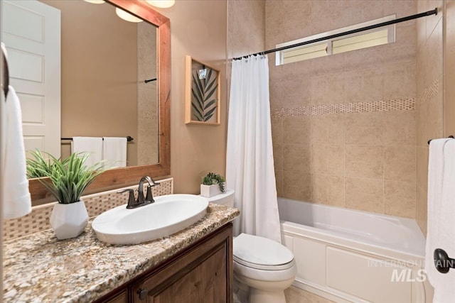 bathroom featuring shower / tub combo, vanity, and toilet