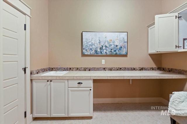 interior space featuring light tile patterned floors and a sink