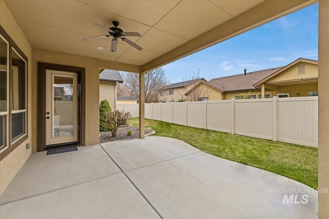 view of patio / terrace with fence and a ceiling fan