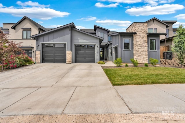 7060 E La Cuesta St, Boise, ID 83716 - contemporary house featuring board and batten siding, an attached garage, stone siding, concrete driveway, and a front lawn