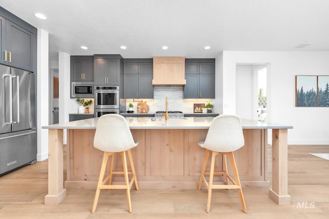 7060 E La Cuesta St, Boise, ID 83716 - kitchen featuring appliances with stainless steel finishes, custom range hood, baseboards, decorative backsplash, and recessed lighting