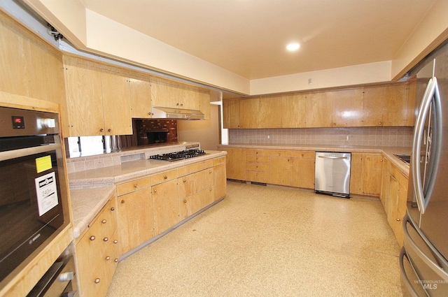 kitchen with light floors, stainless steel appliances, tasteful backsplash, light countertops, and light brown cabinetry