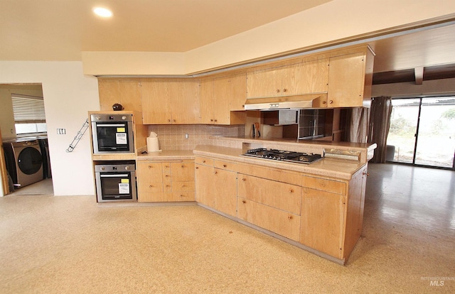 kitchen with washer / clothes dryer, decorative backsplash, appliances with stainless steel finishes, light brown cabinets, and under cabinet range hood