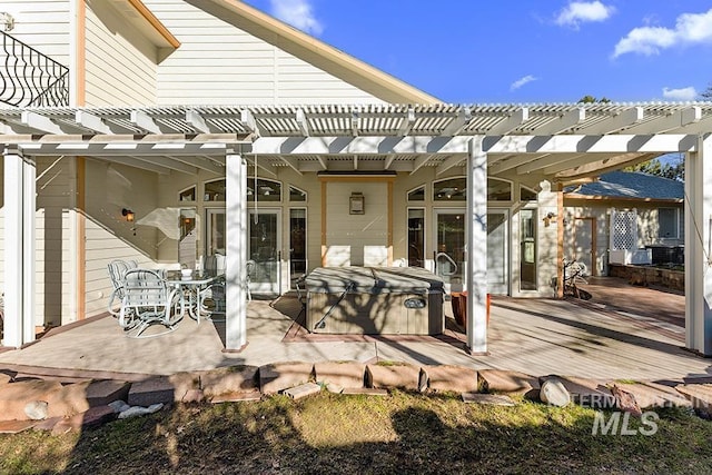 view of patio with a hot tub, a pergola, and a wooden deck