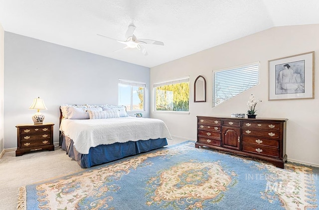 carpeted bedroom with ceiling fan and lofted ceiling