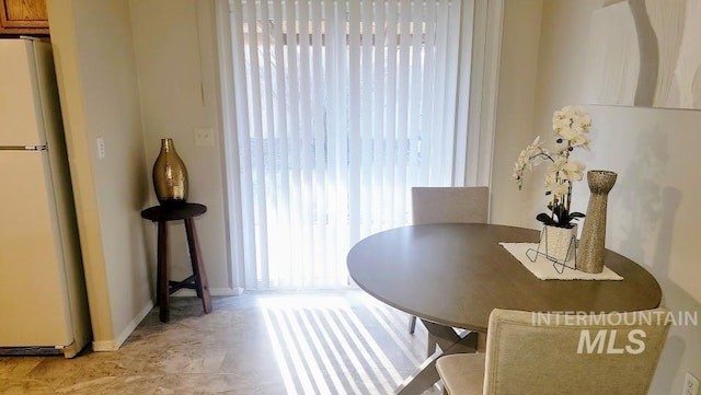 dining space featuring baseboards