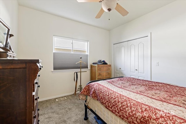 bedroom with carpet floors, a closet, baseboards, and a ceiling fan