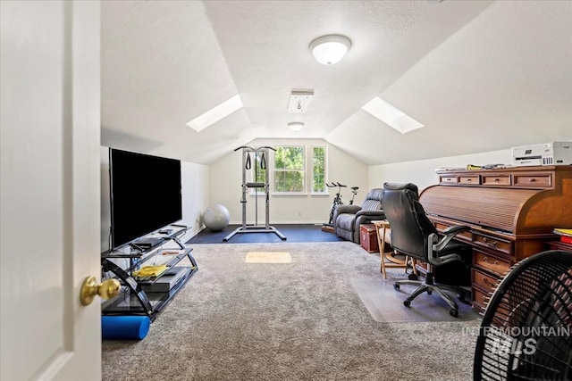 carpeted office with a skylight, lofted ceiling, and baseboards
