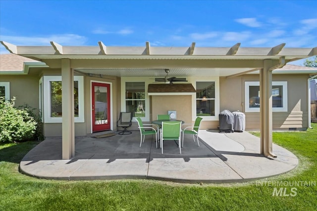 back of house with a ceiling fan, a patio, stucco siding, a yard, and outdoor dining space