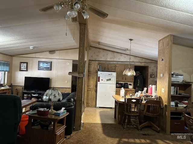 46 Aspen Way, Lowman, ID 83637 - carpeted living area featuring vaulted ceiling, a ceiling fan, and wooden walls