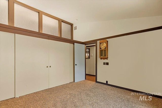spare room with carpet and visible vents