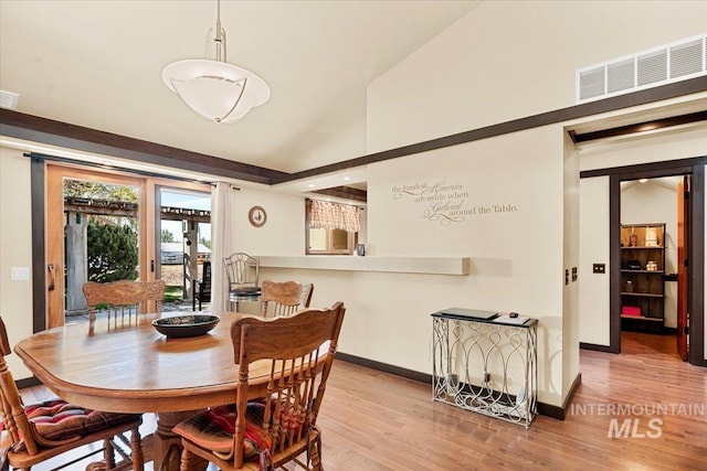 dining space with baseboards, visible vents, and light wood-type flooring