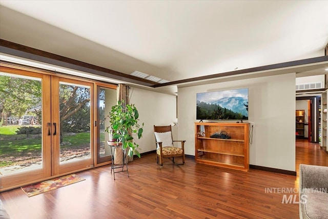 sitting room with baseboards, french doors, wood finished floors, and visible vents