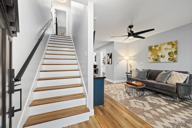 living room featuring light hardwood / wood-style floors and ceiling fan