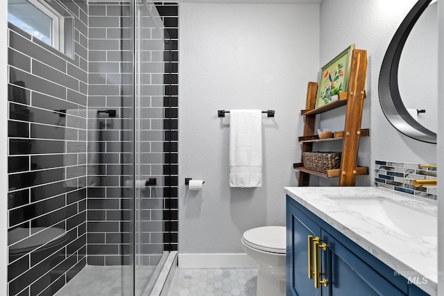 bathroom with vanity, toilet, and an enclosed shower