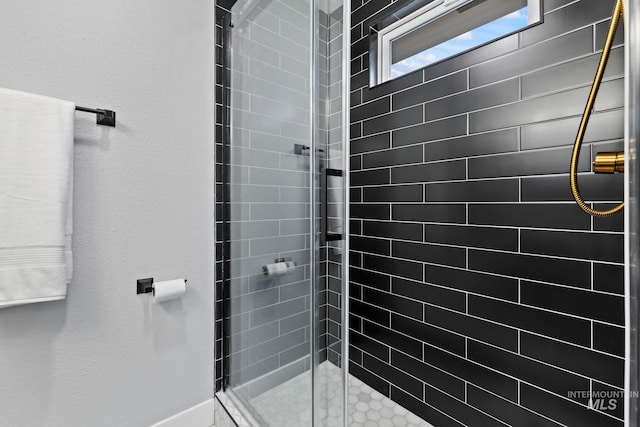 bathroom with tiled shower