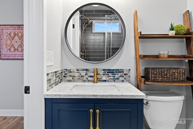 bathroom with decorative backsplash, vanity, hardwood / wood-style flooring, and toilet