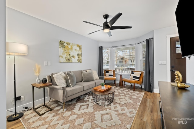 living room with light wood-type flooring and ceiling fan