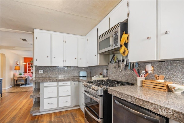 kitchen featuring tile countertops, white cabinetry, stainless steel appliances, and hardwood / wood-style floors