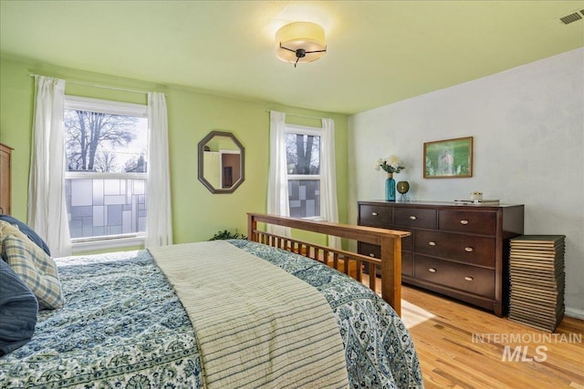 bedroom with visible vents and light wood finished floors