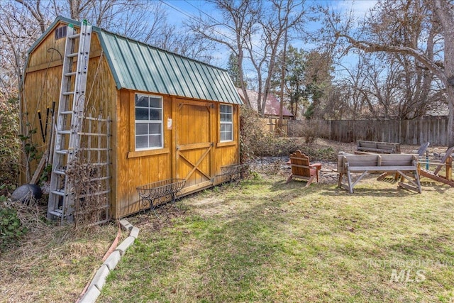 view of shed featuring fence