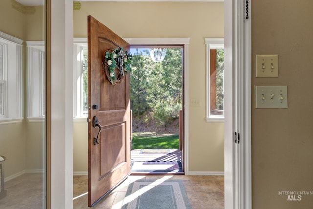 entryway featuring tile patterned floors and baseboards