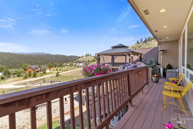 deck with visible vents, a gazebo, and a mountain view